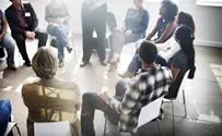 Group of people talking in a circle.