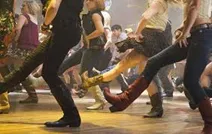 Group of people line dancing.
