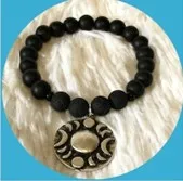 Bracelet with moon phase charm.