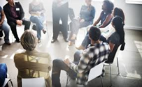 Group of people talking in a circle.