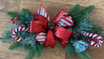Winter theme swag with evergreen, candy cane and big red bow.