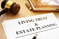 Living Trust and Estate Planning document, gavel and book on a desk.